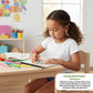 Child drawing with colored pencils in a classroom setting