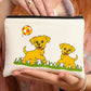 Small pouch with cartoon dogs and a ball design held by a person.