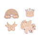 Set of wooden cutouts including a rainbow, cloud, crown, bow, and unicorn on a white background.