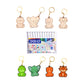 Set of animal-shaped keychains with a pack of DOMS watercolor pens on a white background