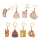 Set of keychains with educational-themed designs on a white background