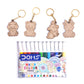 Set of watercolor pens with animal keychains on a white background